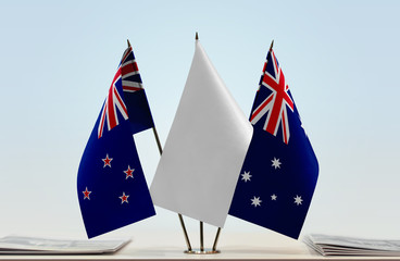 Flags of New Zealand and Australia with a white flag in the middle