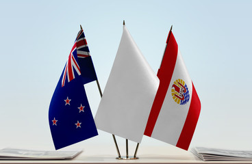 Flags of New Zealand and French Polynesia with a white flag in the middle