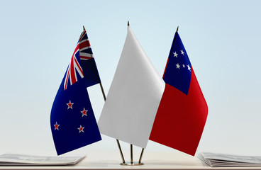 Flags of New Zealand and Samoa with a white flag in the middle