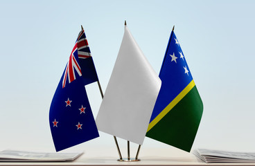Flags of New Zealand and Solomon Islands with a white flag in the middle