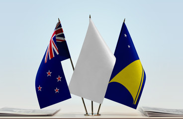 Flags of New Zealand and Tokelau with a white flag in the middle