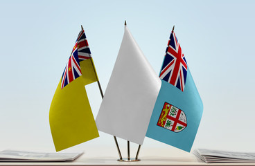 Flags of Niue and Fiji with a white flag in the middle