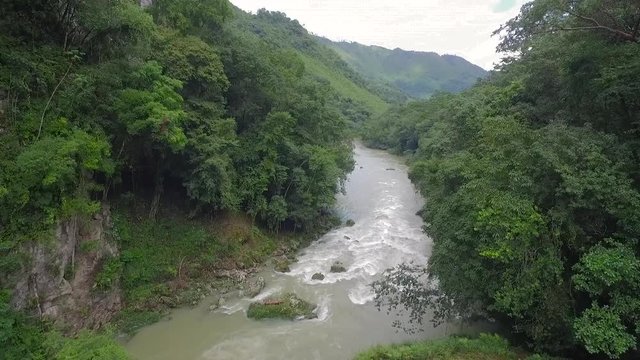 An aerial over remarkable waterfalls and green polls on the Semuc Champey river in Guatemala.