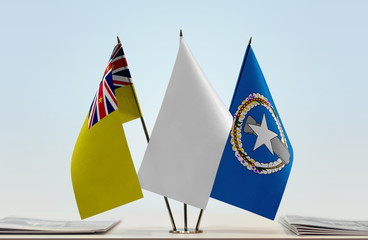 Flags of Niue and Northern Mariana Islands with a white flag in the middle