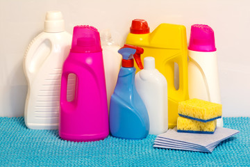 Set of multi-colored plastic containers for household chemicals, cleaning products for home use.