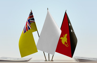 Flags of Niue and Papua New Guinea with a white flag in the middle