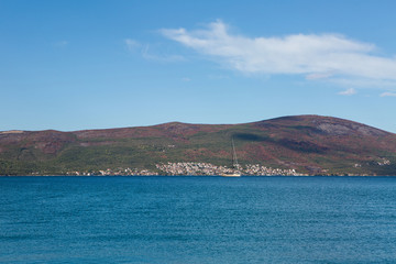 white large yacht stands at the pier in the town of Tivat