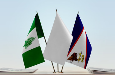 Flags of Norfolk Island and American Samoa with a white flag in the middle