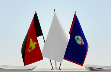 Flags of Papua New Guinea and Guam with a white flag in the middle