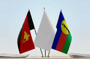 Flags of Papua New Guinea and New Caledonia with a white flag in the middle