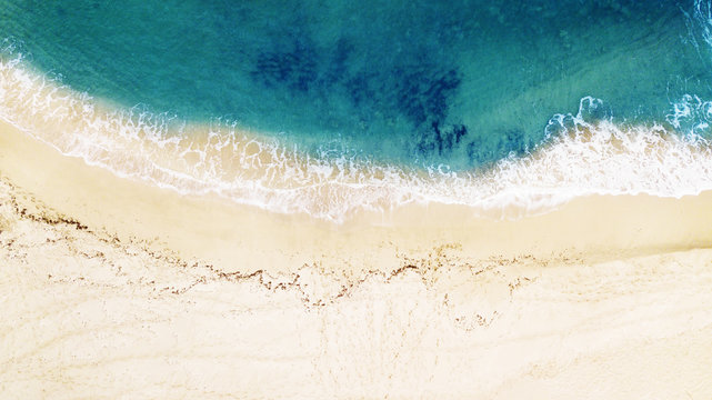 Beautiful tropical empty beach and sea waves. Aerial view.
