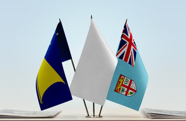 Flags of American Samoa and Fiji with a white flag in the middle