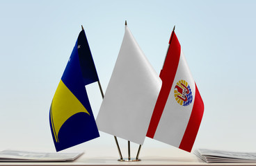 Flags of American Samoa and French Polynesia with a white flag in the middle