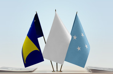 Flags of American Samoa and Federated States of Micronesia with a white flag in the middle