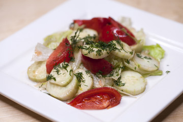 Fresh vegetable salad and bread on a table
