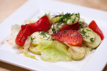 Fresh vegetable salad and bread on a table