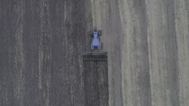 The combine removes the mote that has remained after mowing. A beautiful pattern on the ground after cutting the glass. View from above. Aerial view. 4k Video