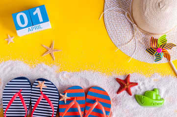 April 1st. Image of april 1 calendar with summer beach accessories and traveler outfit on...