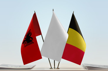 Flags of Albania and Belgium with a white flag in the middle