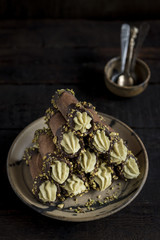 Traditional Italian dessert cannoli with pistachios served on the plate,selective focus
