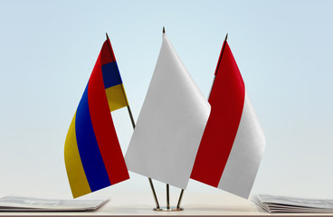 Flags of Armenia and Monaco with a white flag in the middle