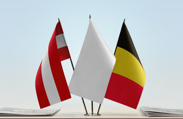 Flags of Austria and Belgium with a white flag in the middle