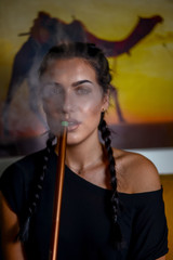 Fototapeta premium Young hot girl smoking shisha