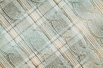 Textile background  in vintage style -- flannel, cotton into the classic scottish cell and knitted textured with a pattern, double exposure photo