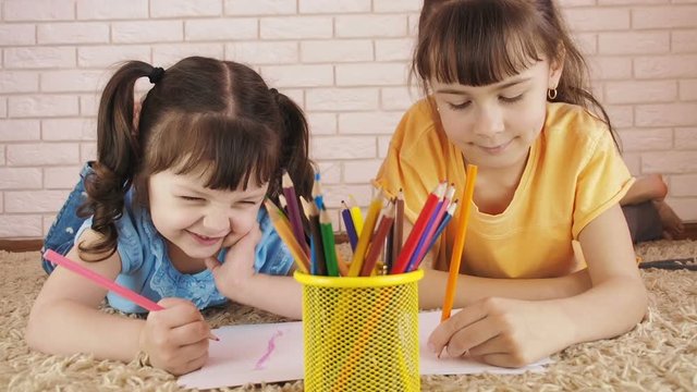 Children with pencils. Sisters are painted with pencils.