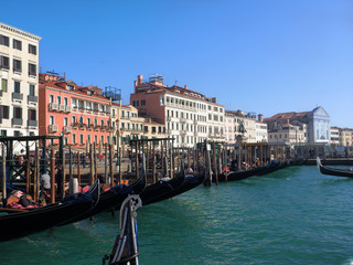 Fototapeta na wymiar urban landscape with moored gondolas at Grand Canal (Canal Grande) in Venice, Italy