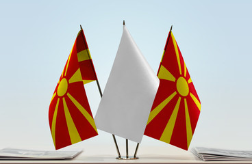 Two flags of Macedonia with a white flag in the middle