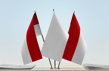 Two flags of Monaco with a white flag in the middle