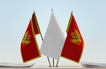 Two flags of Montenegro with a white flag in the middle