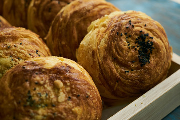 Homemade Azerbaijan national pastry Gogal on rustic wooden table background. Novruz holiday with Azerbaijan national pastry sweet and salty gogal, closeup. Delicious dessert holiday food