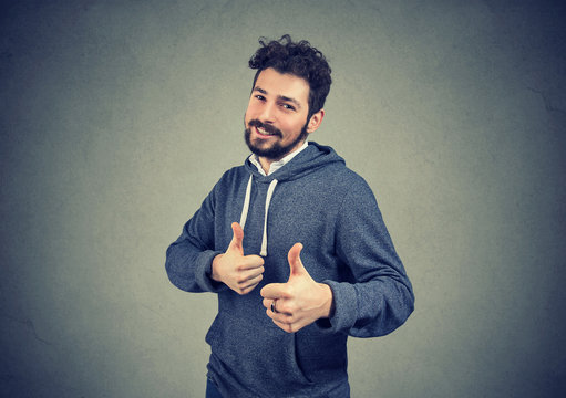 cheerful man excited with win showing thumbs up