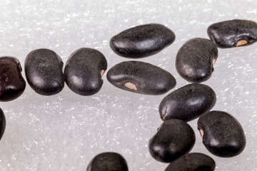 Super macro of black beans on white background