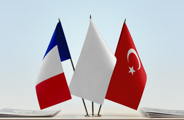 Flags of France and Turkey with a white flag in the middle