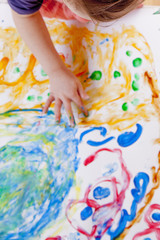 Obraz na płótnie Canvas Child girl painting with colorful hands. ( people, childhood, drawing concept)