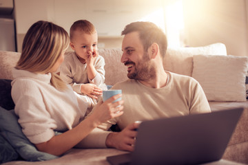 Portrait of a joyful family using a laptop