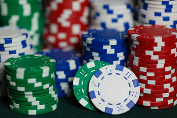 stacks of poker chips on a poker table in a casino representing a win after gambling. 