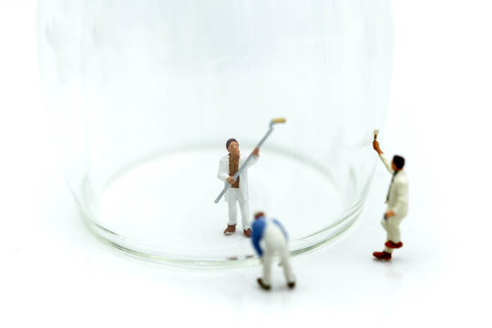 Miniature people : worker clean a glass.