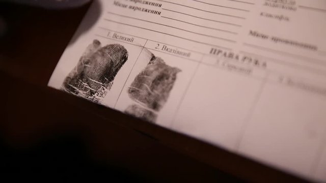 A man is being fingerprinted. Taking fingerprints from suspect. Closeup