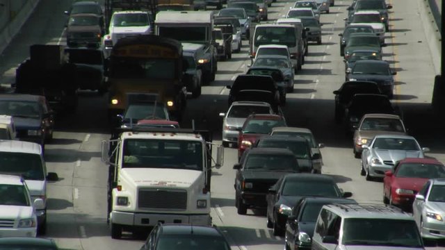 Traffic moves slowly along a busy freeway in Los Angeles.