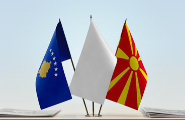 Flags of Kosovo and Macedonia with a white flag in the middle