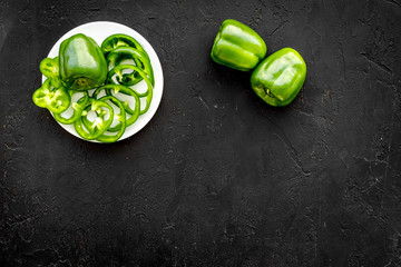 Vegetables for greeny smoothy with pepper on black background top view mock up