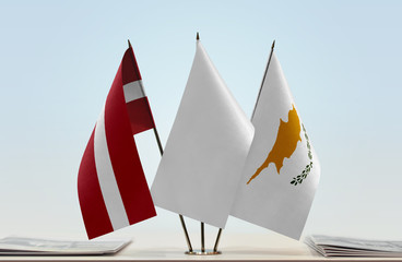 Flags of Latvia and Cyprus with a white flag in the middle