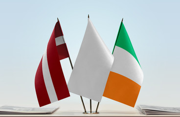 Flags of Latvia and Ireland with a white flag in the middle