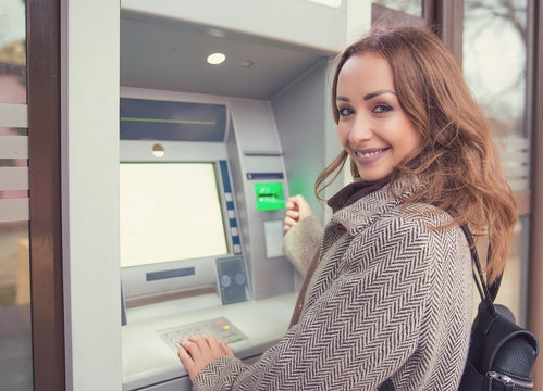 Young Happy Woman Using ATM