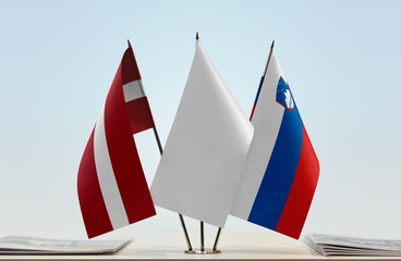 Flags of Latvia and Slovenia with a white flag in the middle