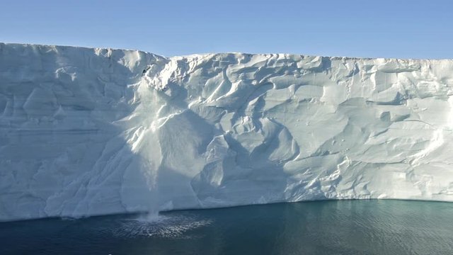 A waterfall flows off the Austfonna icecap in Norway suggesting global warming.